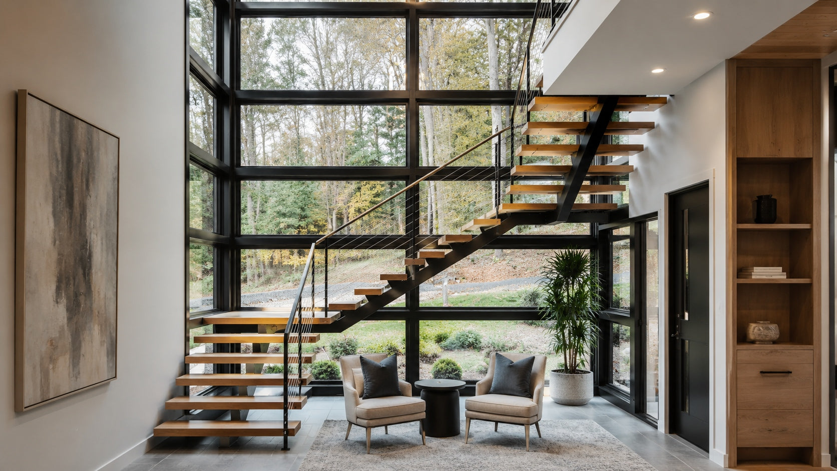 Contractor installing a modern floating stair system with white oak treads and a matte black steel mono stringer