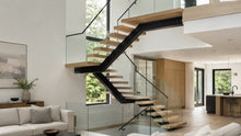 Modern glass floating stairs in a bright contemporary residential interior