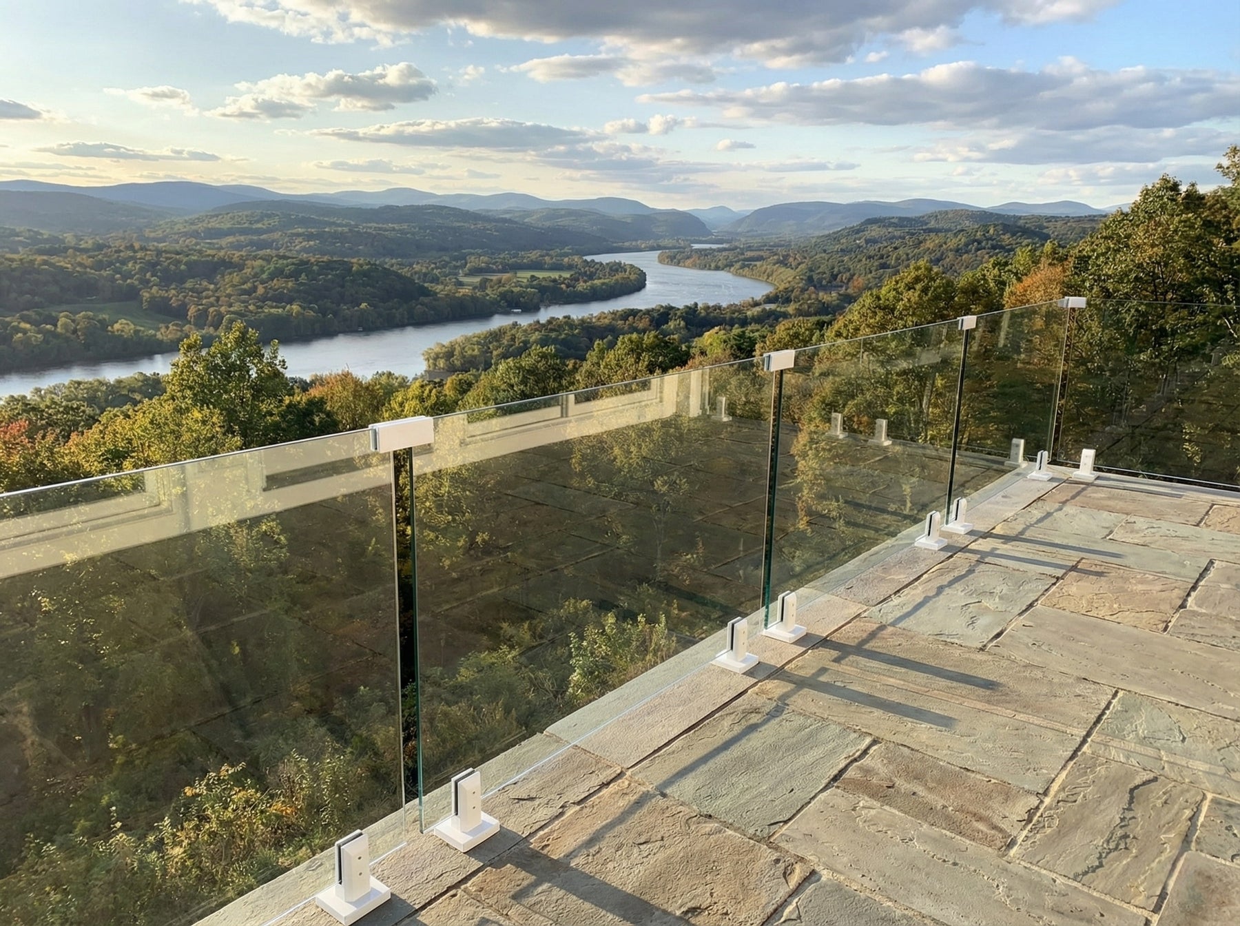 Floating stair system with wood treads and clear glass railing in a bright modern residential space