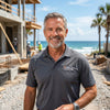 Confident headshot of Marcus Vance, an experienced General Contractor in Florida specializing in coastal luxury homes, on an active construction site for contemporary floating stairs by Elevated Stairs.