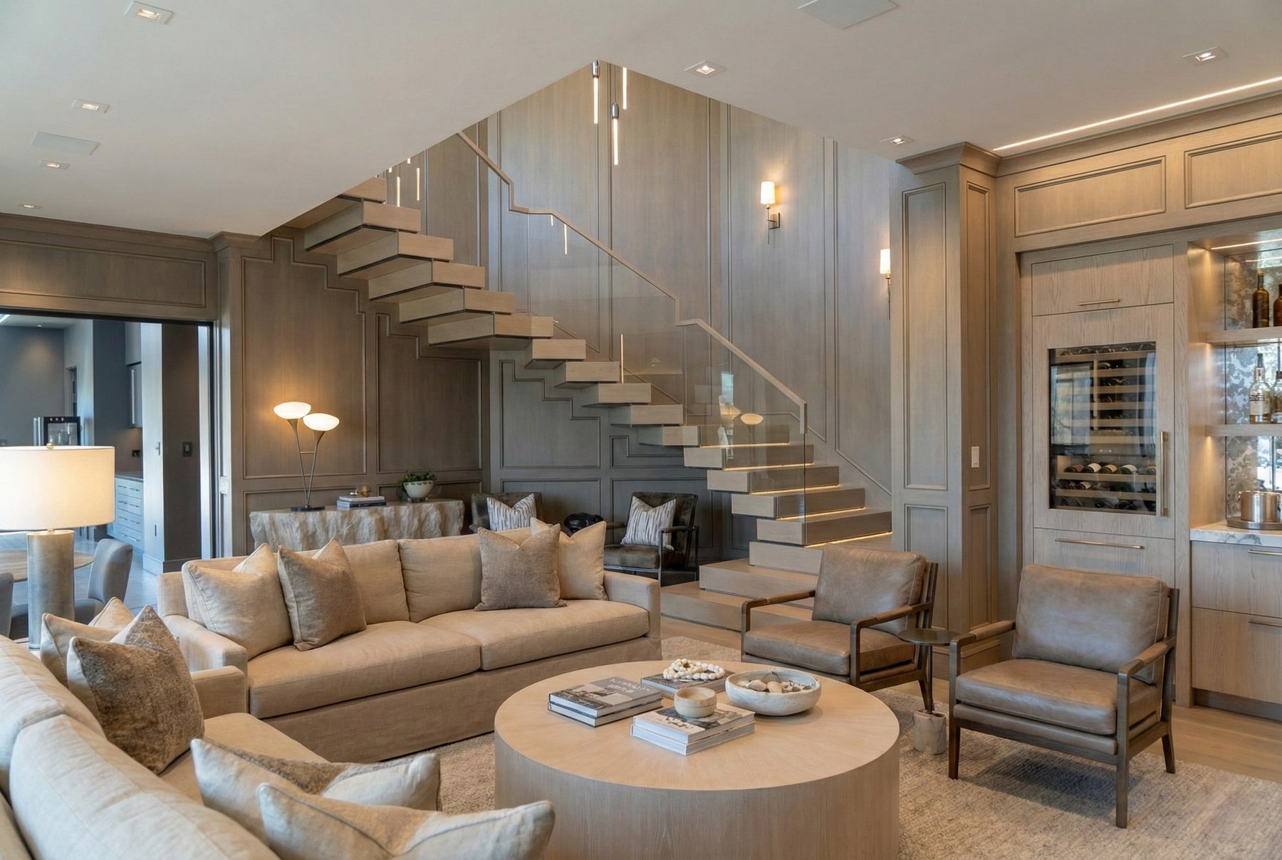 Custom floating stair system with wood treads and glass railing in a modern residential interior